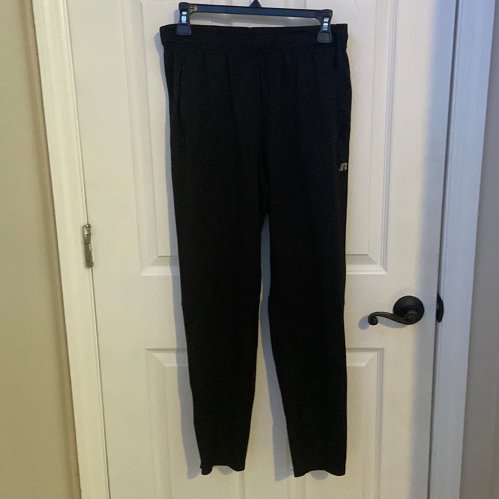 Black Russell joggers zippers on legs to adjust fit and zip able pockets
